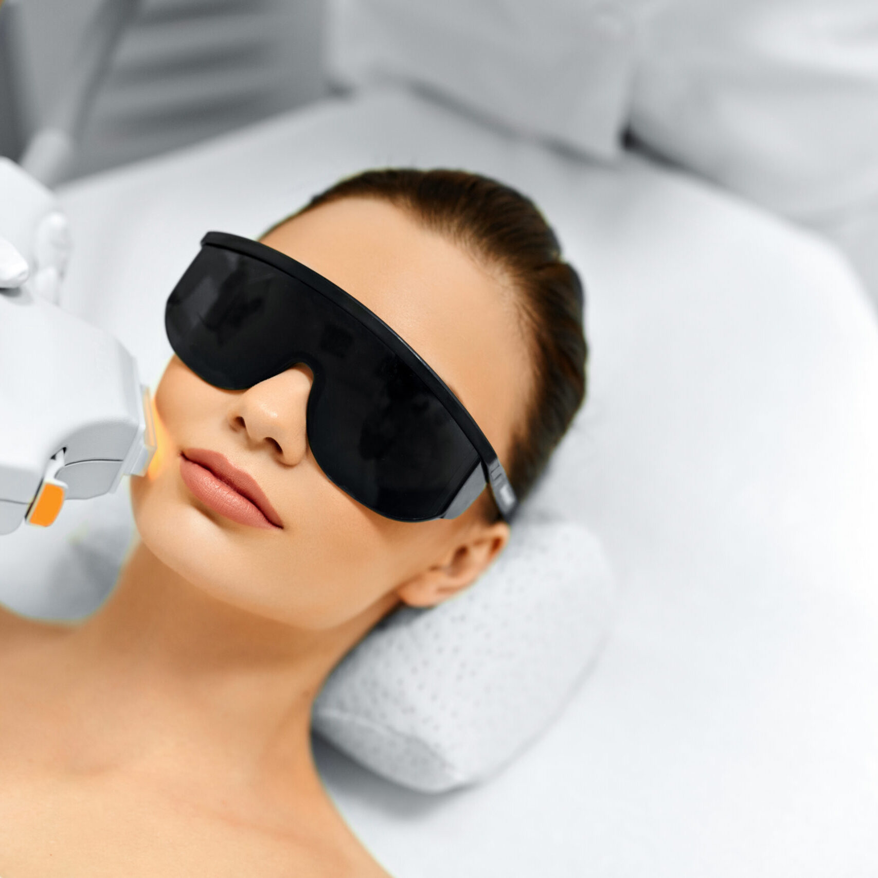 Skin Care. Young Woman Receiving Facial Beauty Treatment, Removing Pigmentation At Cosmetic Clinic. Intense Pulsed Light Therapy. IPL. Rejuvenation, Photo Facial Therapy. Anti-aging Procedures.